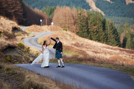 Dancing wedding couple in the highlands